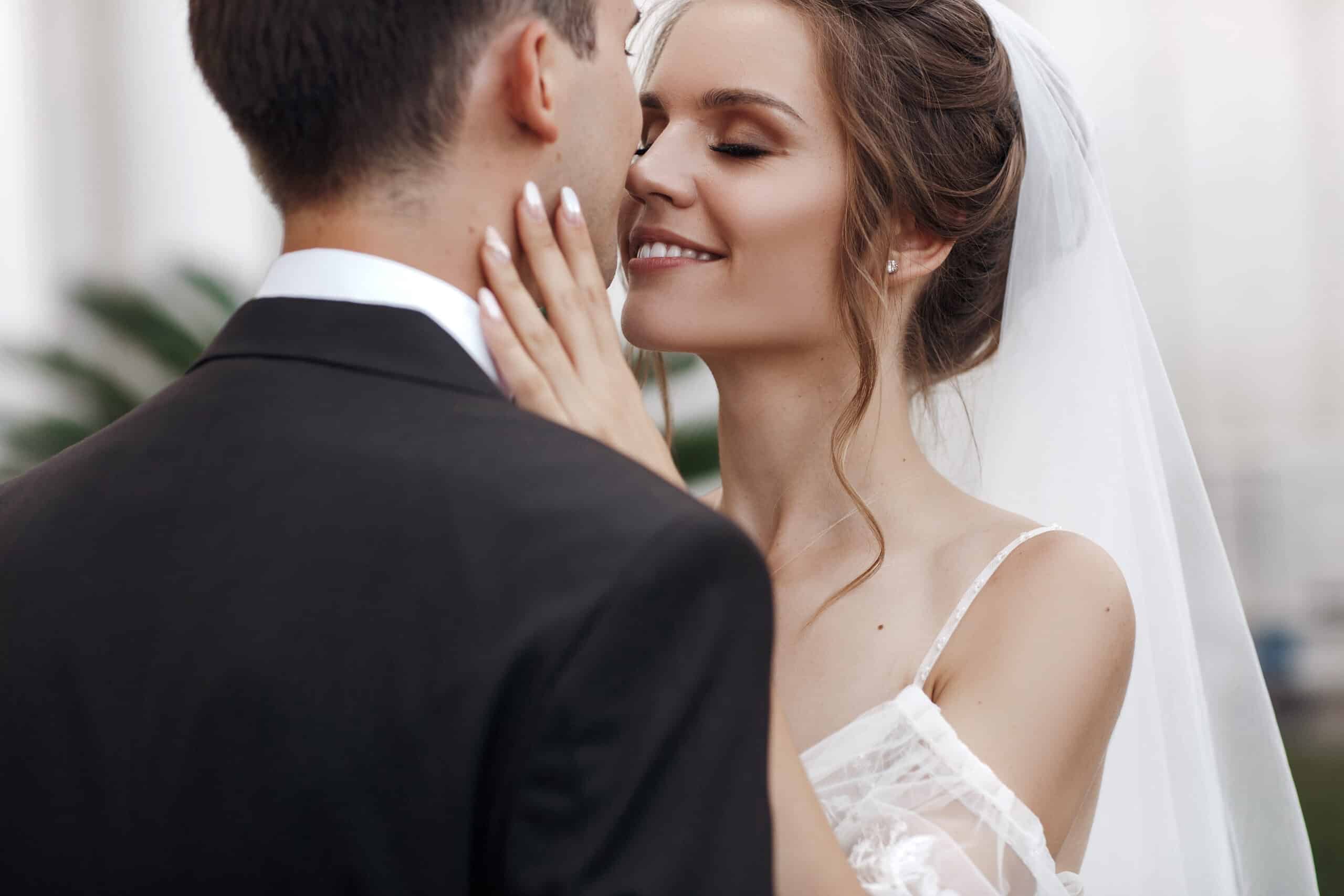 Bride and groom in wedding dress outdoors on celebration day